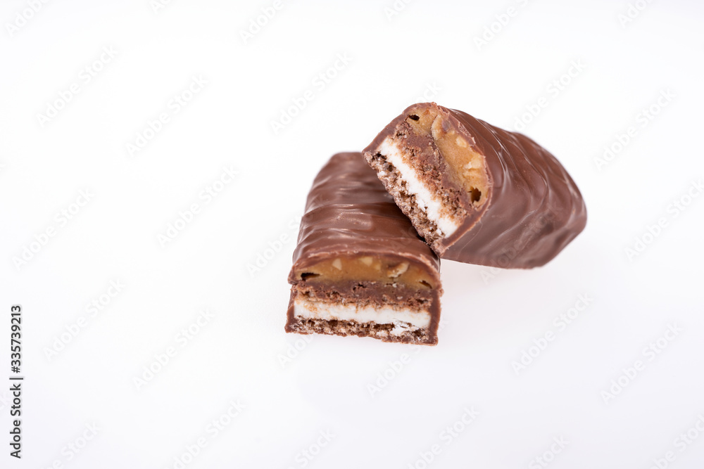Chocolate peanut butter energy bar with peanuts isolated on white Chocolate peanut butter energy bar with peanuts isolated on white