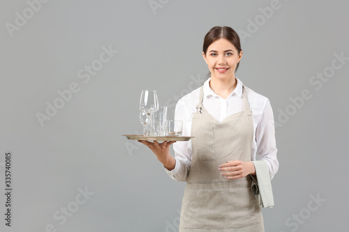 Photography Portrait of female waiter on grey background
