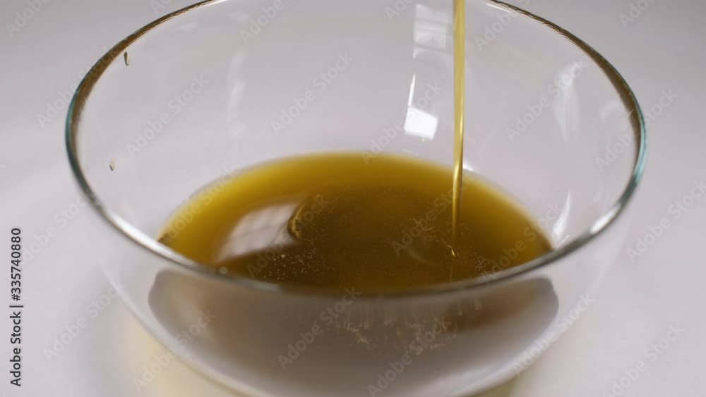 Close up of home made ointment creating process. Adding olive oil into herb infused oil base. 4K resolution Close up of home made ointment creating process. Adding olive oil into herb infused oil base. 4K resolution