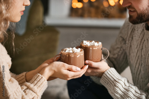 Happy young couple drinking...