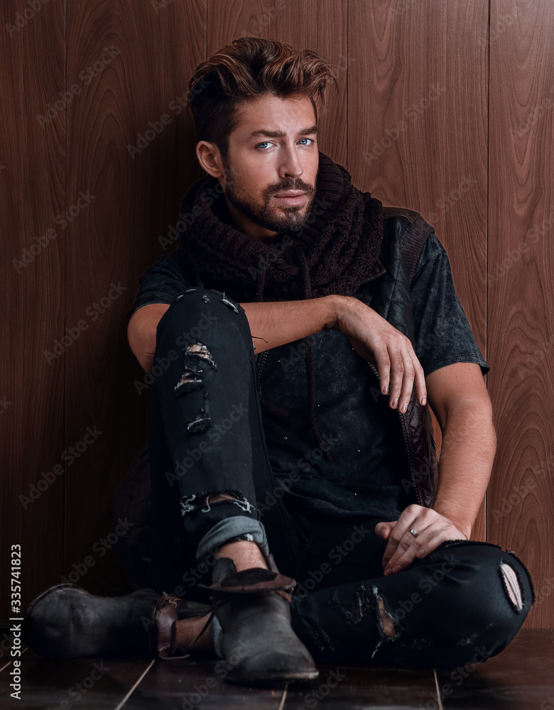 Handsome mature man sitting by the brick wall. Men's fashion. Handsome mature man sitting by the brick wall. Men's fashion.