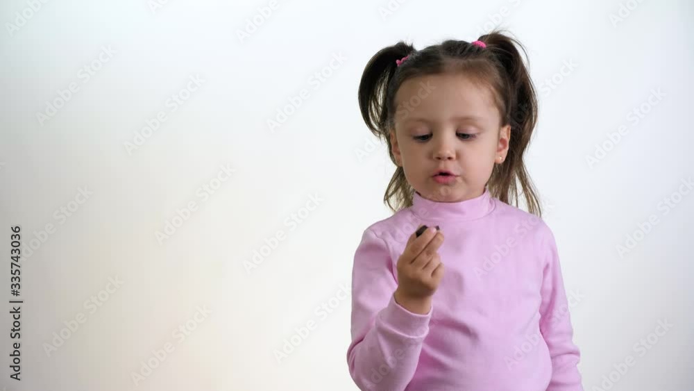 Cute little girl eating chocolate isolated on white background Cute little girl eating chocolate isolated on white background