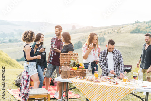 Wallpaper Mural Happy friends eating at picnic lunch in italian vineyard outdoor - Young people having fun on gastronomic weekend tuscany tour - Friendship, summer and food concept - Main focus on center man face Torontodigital.ca