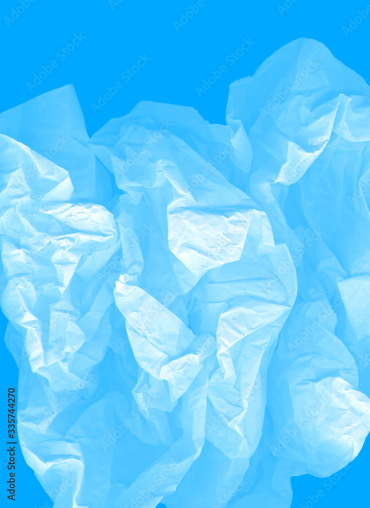 Airy vertical image. Blue large light elegant cloud of crumpled paper on a cyan background. Crushed, creased and wrinkled paper. The concept of lightness, transparency. A modern perfect image for text Airy vertical image. Blue large light elegant cloud of crumpled paper on a cyan background. Crushed, creased and wrinkled paper. The concept of lightness, transparency. A modern perfect image for text