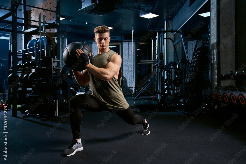 Sportsman doing lunges using ball. Sportsman doing lunges using ball.