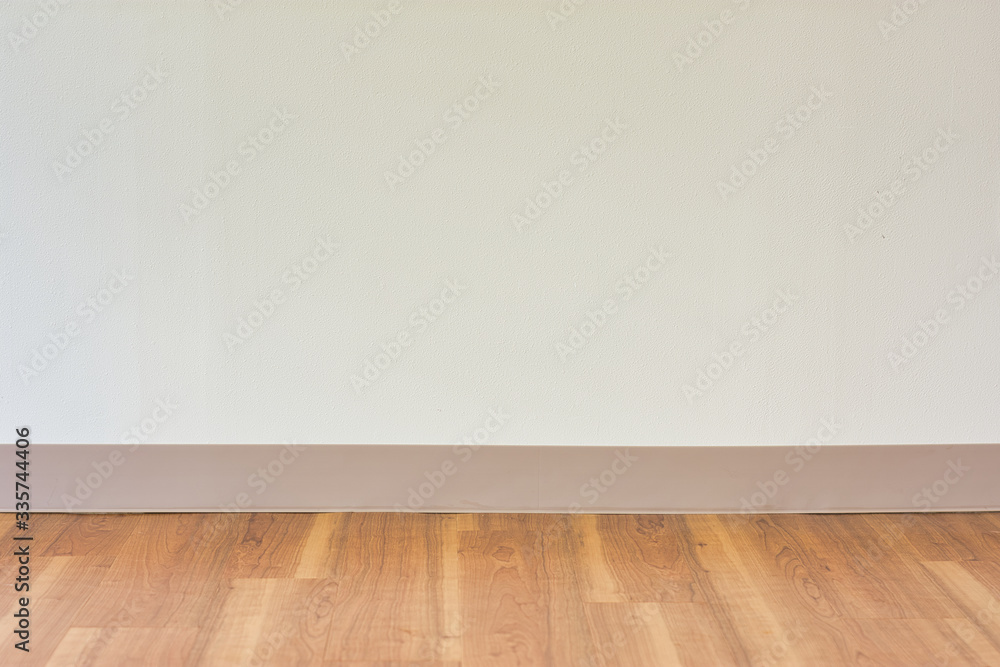 Blank white wall over wooden floor Blank white wall over wooden floor