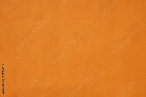 orange wall covered with plaster with small cracks