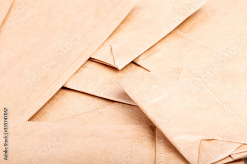 Photos A pile of many small brown eco new paper recyclable food bags detail abstract background texture pattern macro, closeup