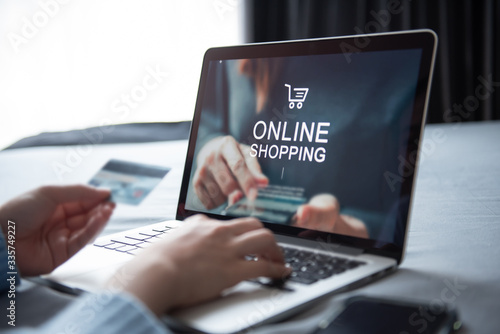 E-commerce and online shopping concept, Woman hand using laptop (Mockup website) and holding credit card for shopping payment online at home.