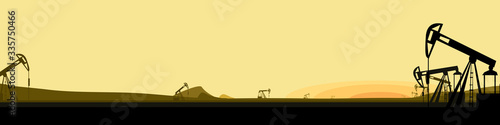 long vector banner with silhouettes of oil production facilities on the background of the evening landscape. oil industry at sunset