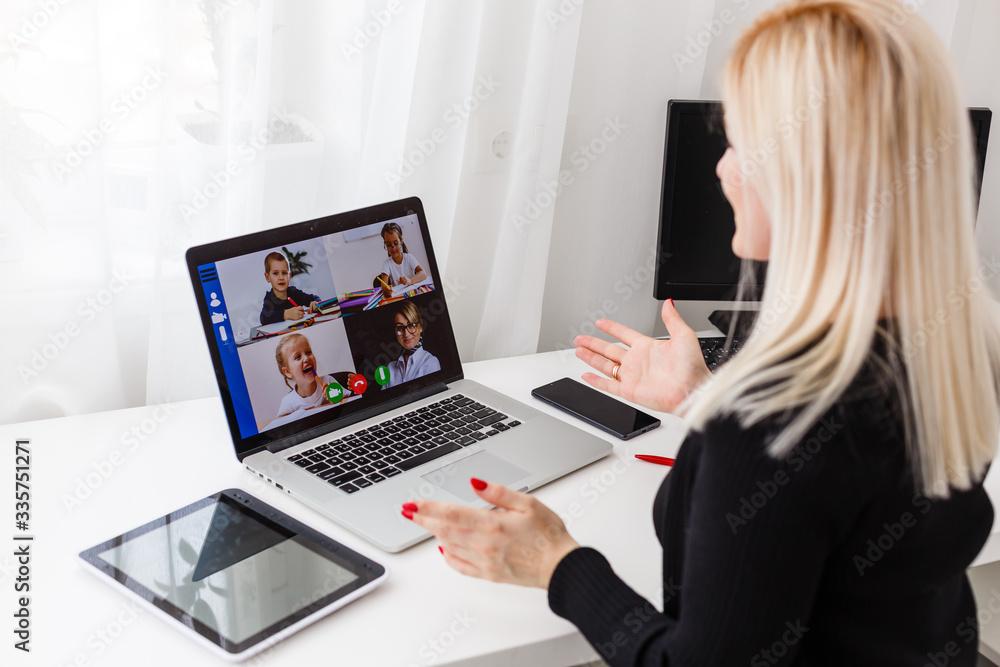 Teacher, tutor or professor with headset, laptop and camera in her office explaining something at an online lesson or video lecture, webinar Teacher, tutor or professor with headset, laptop and camera in her office explaining something at an online lesson or video lecture, webinar