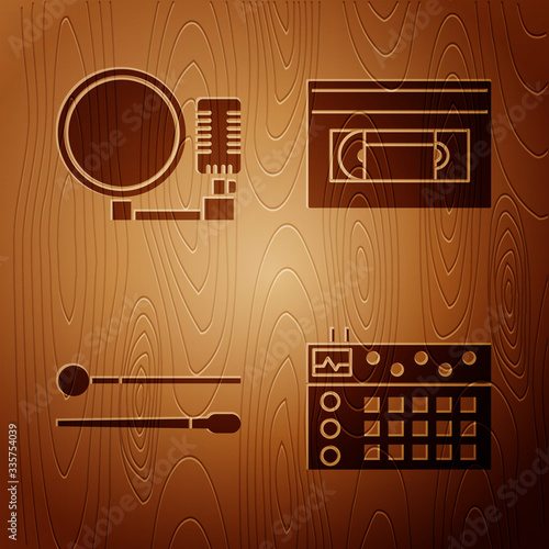 Set Drum machine, Microphone, Drum sticks and VHS video cassette tape on wooden background. Vector