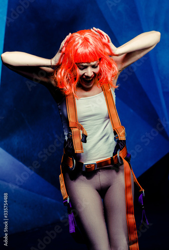 Fototapeta Naklejka Na Ścianę i Meble -  Sci-fi girl. Futuristic background of a starship. Girl screaming. Very expression face, red hair.