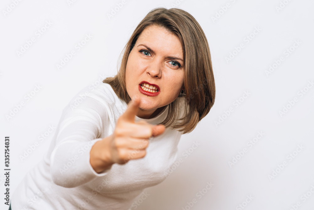 studio portrait of a beautiful girl pointing to the camera studio portrait of a beautiful girl pointing to the camera