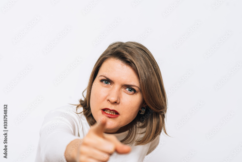 studio portrait of a beautiful girl pointing to the camera studio portrait of a beautiful girl pointing to the camera