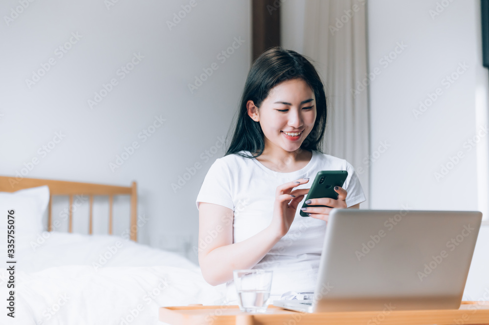 Asian young women use laptops at home Asian young women use laptops at home