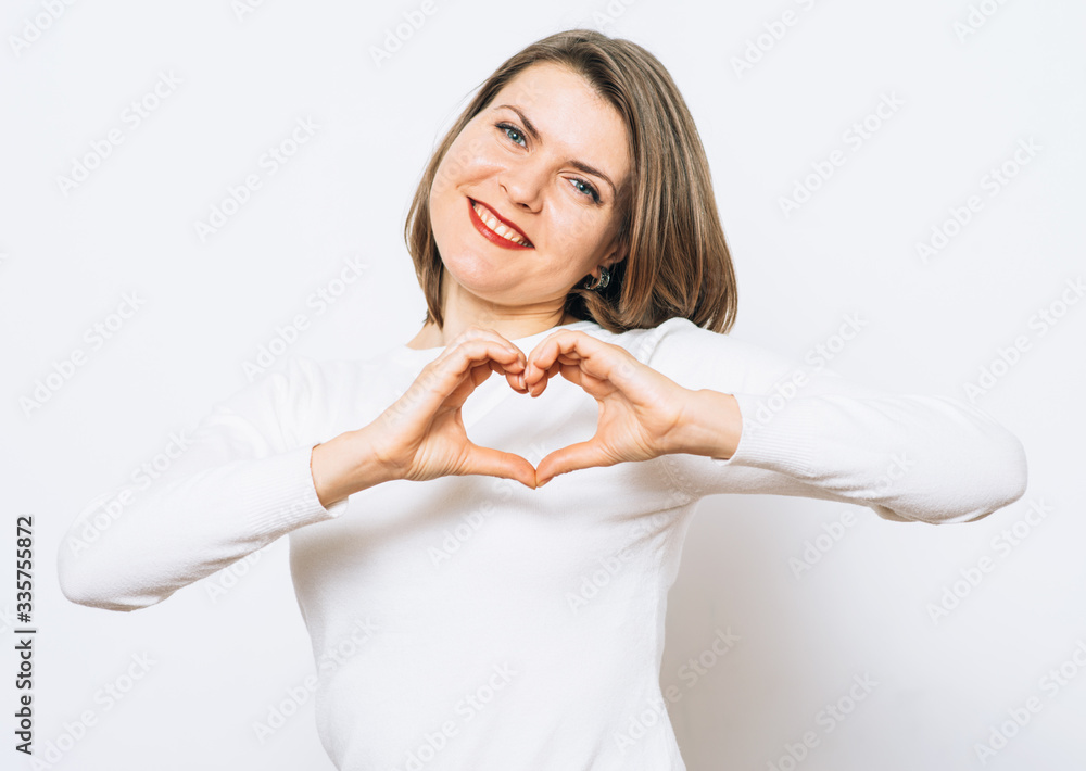 woman making a hand heart frame woman making a hand heart frame