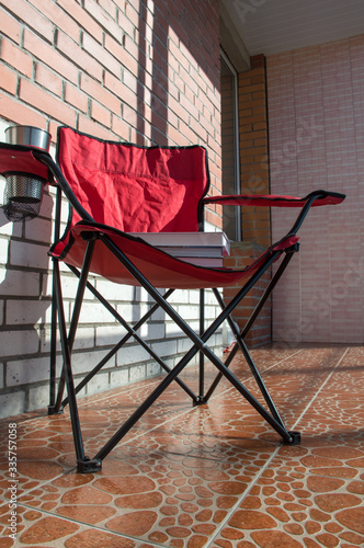 red chair in sunny balcony 