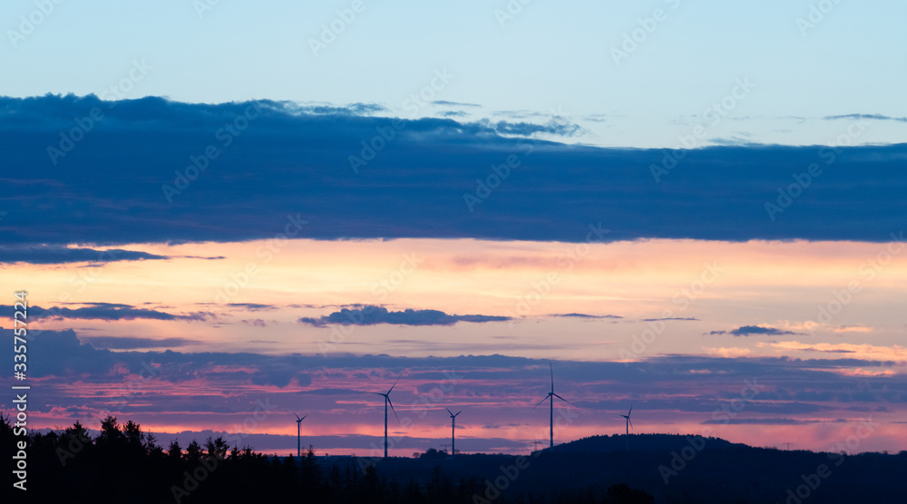 Wind turbines on a background of orange sunset sky