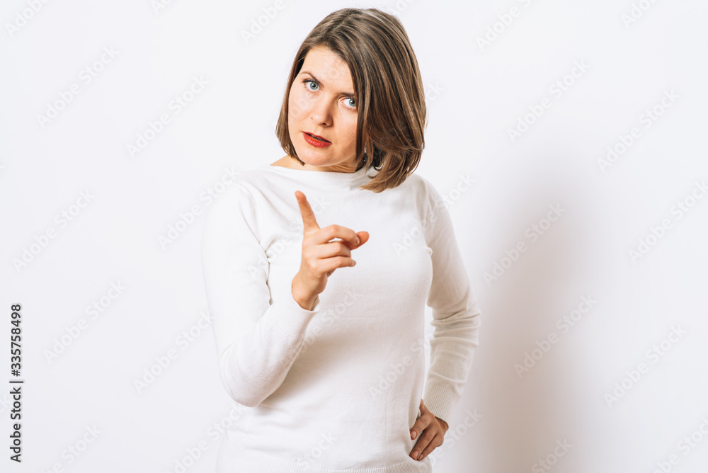 studio portrait of a beautiful girl pointing to the camera studio portrait of a beautiful girl pointing to the camera