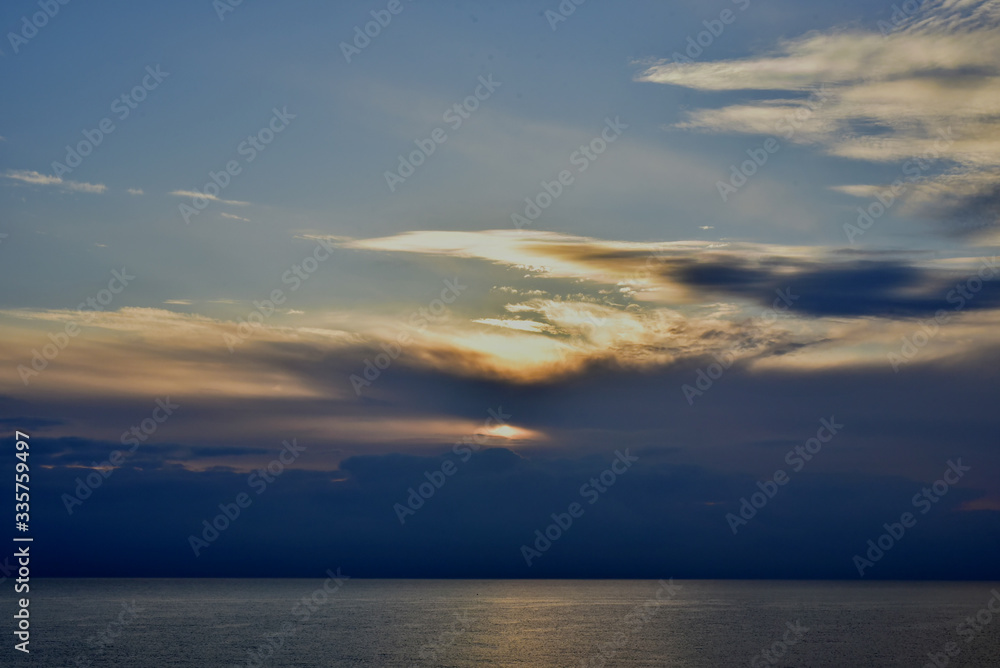 A sunset in the clouds above the sea 