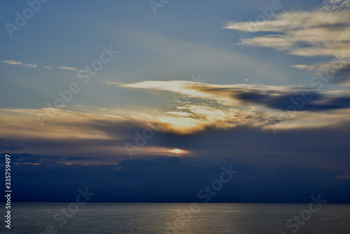 A sunset in the clouds above the sea 