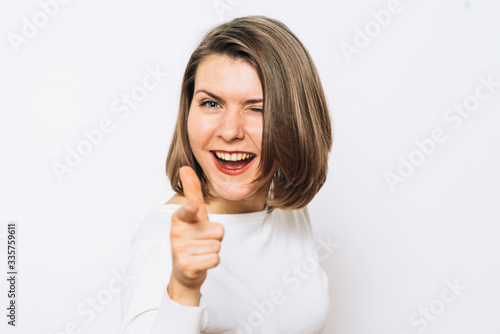 Wallpaper Mural studio portrait of a beautiful girl pointing to the camera Torontodigital.ca