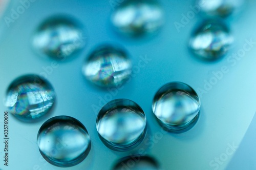 Drops of water on a compasc disc with blue filter in macro view