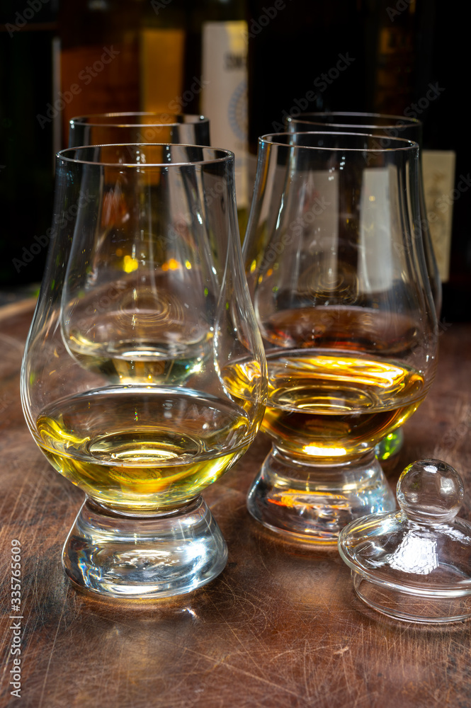 Tasting of flight of Scotch whisky from special tulip-shaped glasses on distillery in Scotland, UK