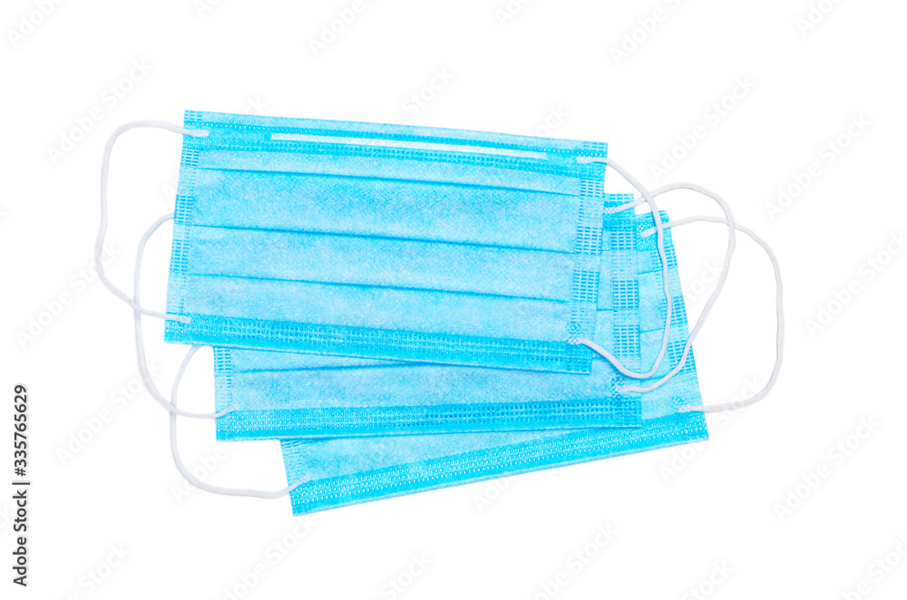 Three blue medical facial masks isolated on a white background. medical care concept Three blue medical facial masks isolated on a white background. medical care concept