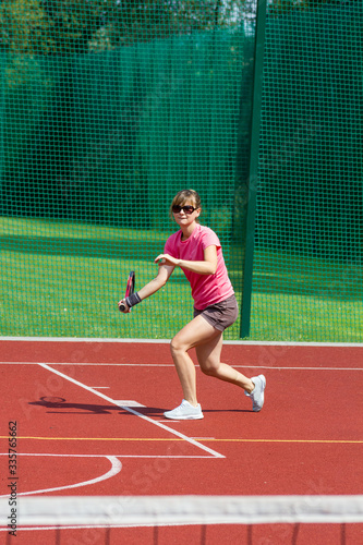 Female tennis player preparing to hit a forehand © ffolas