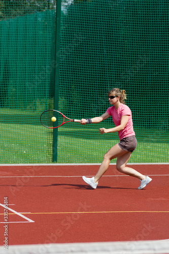 Female tennis player hitting forehand