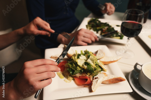 Two young successful women are having dinner in a restaurant and talking