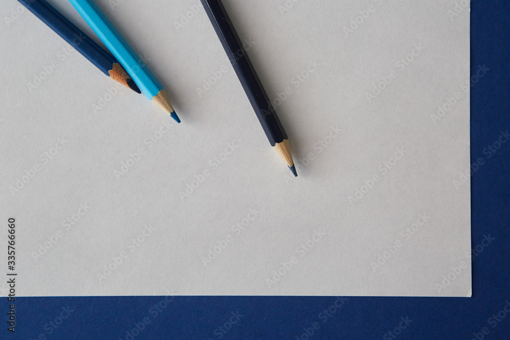 Several colored pencils of blue hues lie on a bright blue-white background Several colored pencils of blue hues lie on a bright blue-white background