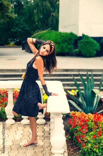 beautiful glamorous teen woman walks among flower beds in a city park © kravik93