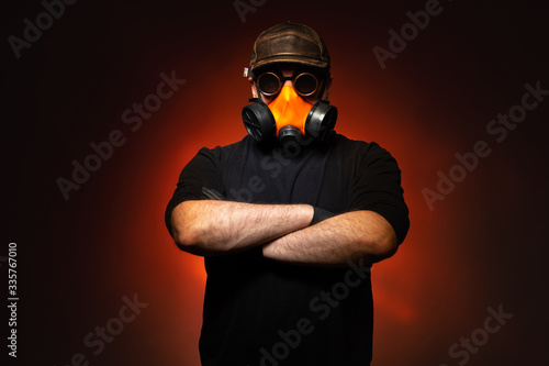 Man in a gas mask on a dark...