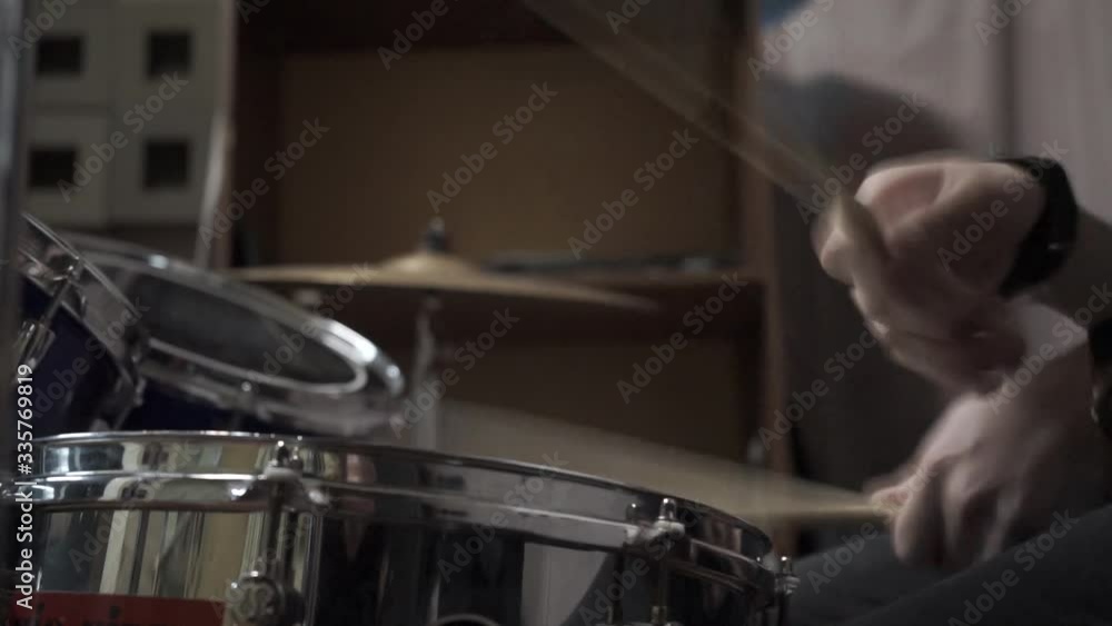 Drummer plays drums kit. Drummer hand silhouette with drumstick. rehearsal of musicians