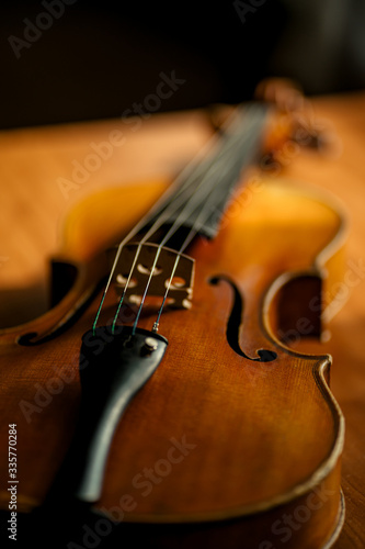 close-up photo of violin on wooden table. classical music instrument, music concept