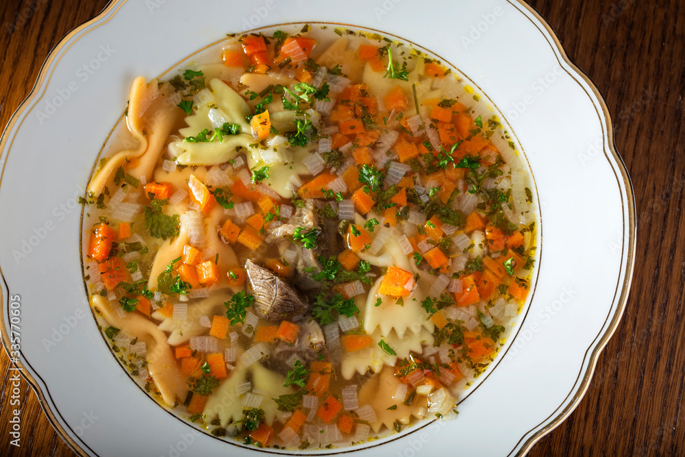 Beef soup with vegetables and fresh chopped parsley