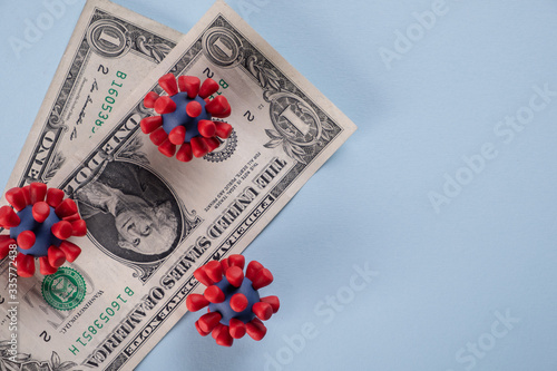 Tableau sur toile American dollars,  coins and models of covid-19 virus on blue background