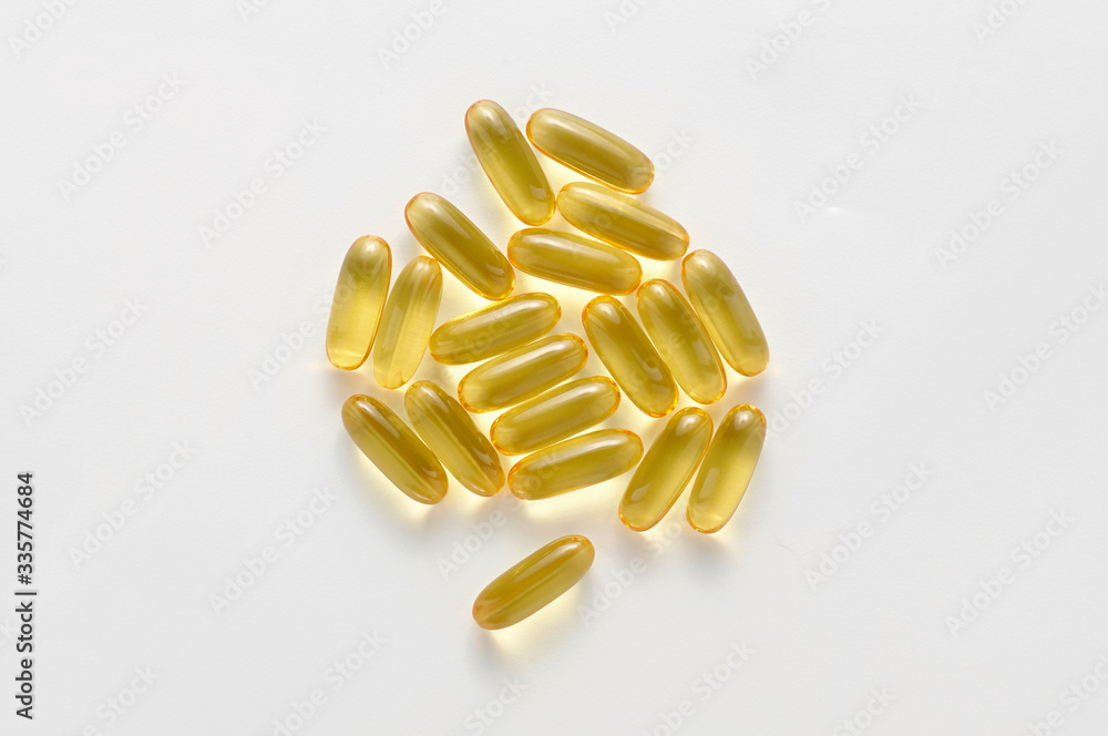 Heap pills of black cumin seeds essential oil Nigella Sativa on white background