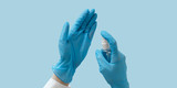 Hand with medical gloves and sanitizer, desinfection, protection against coronavirus.