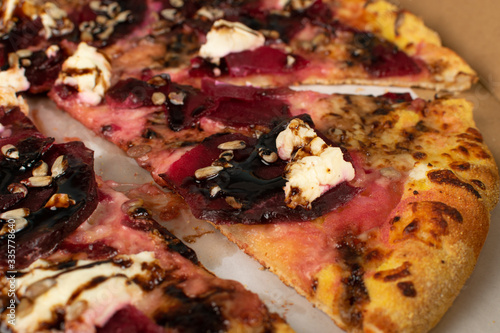 egetarian beetroot pizza with cheese, sliced pickled beet, nuts photo