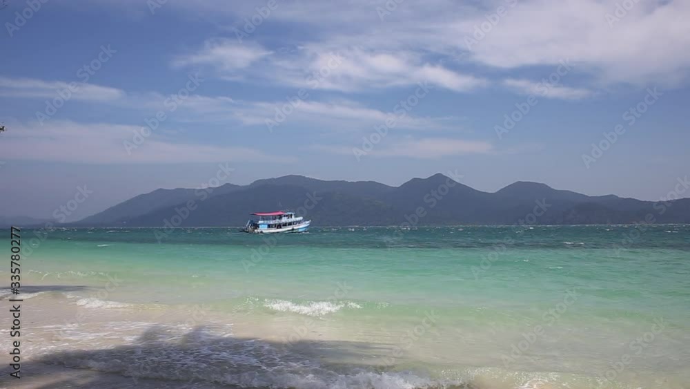 tourist boat sailing on the ocean among tropical islands tourist boat sailing on the ocean among tropical islands