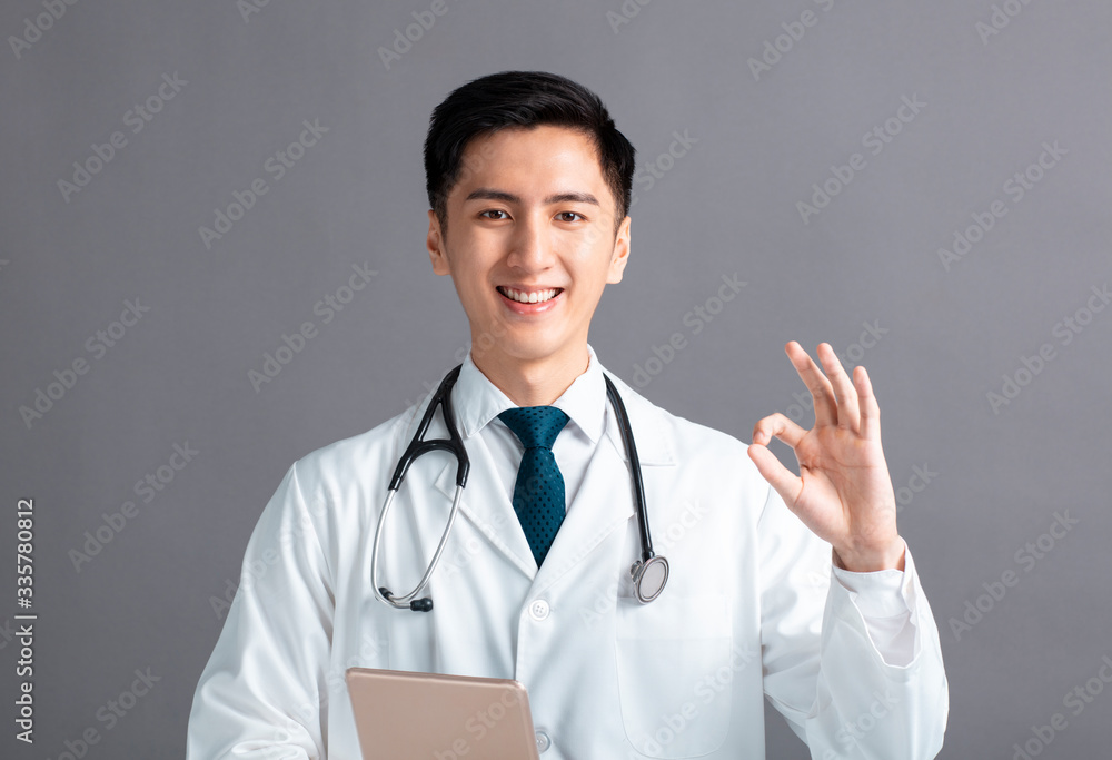 Portrait of male asian young doctor hand with ok sign Portrait of male asian young doctor hand with ok sign