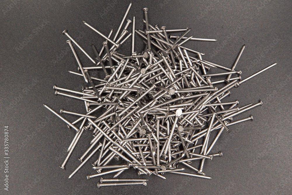 Nails construction on a black background. NILES FOR BUILDING BUILDINGS. SALE OF BUILDING MATERIALS. metal products