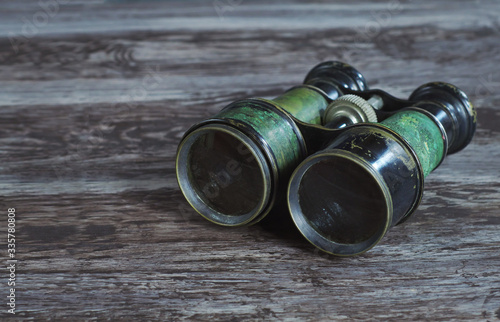 Α pair of vintage military binoculars on an old table 