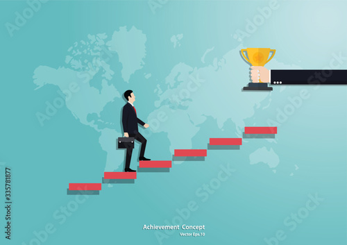 Businessman running up the staircase to trophy cup