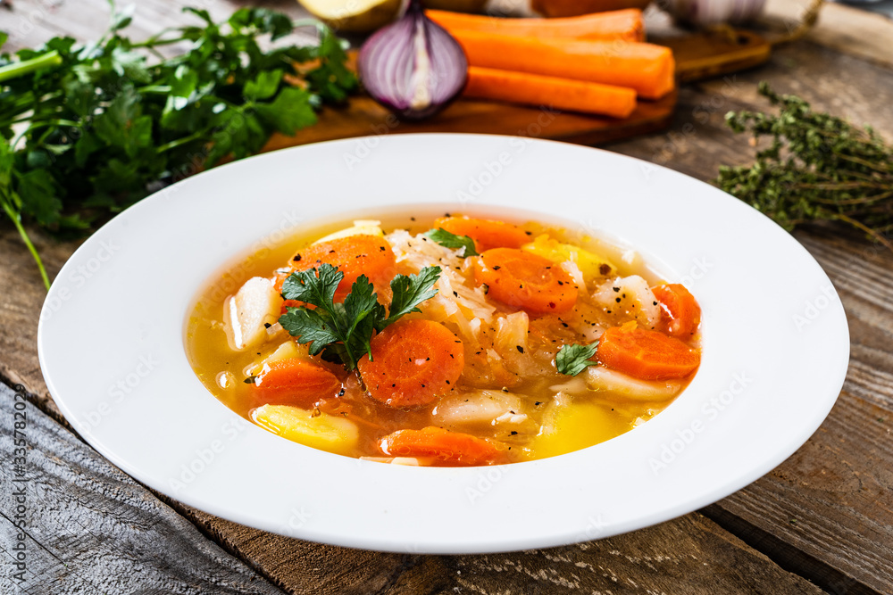 Bowl of hot cabbage soup on wooden table Bowl of hot cabbage soup on wooden table
