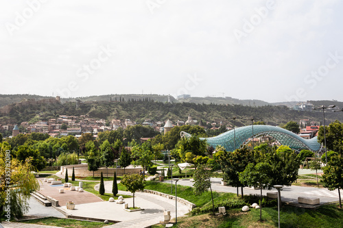 Beautiful shot of Rike Park and modern Bridge of Peace over the Kura (Mtkvari) river and  in cloudy day in Old Town Tbilisi, Georgia.